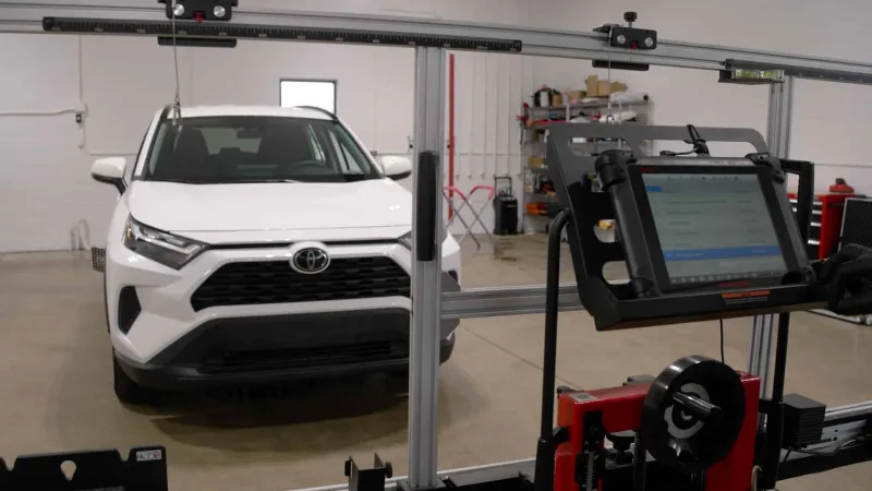 ADAS calibration rig set up in front of an SUV in the shop