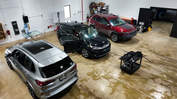 Vehicles in the Action Glass work bay in Jenison
